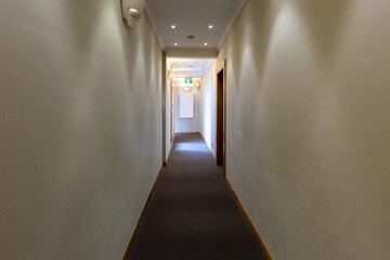  Interior of a hotel corridor with doors with room nummbers