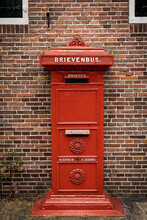 Traditional Old Dutch Red Postbox Mounted In A Cotswold Stone Wall