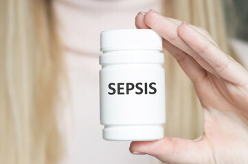 Wall Mural - Medicine and health concept. SEPSIS inscription on the jar in the girl's hand