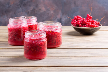 Wall Mural - Schisandra chinensis jam on wooden table. Five-flavor berries with sugar in a glass jar