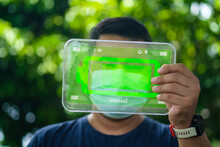 Hand Showing A Transparent Glass Tablet With An Icon A Technology Is Charging The Wireless Battery, Eco-friendly Device Concept. Environment And Conservation. Energy Saving Concept, Solar Power