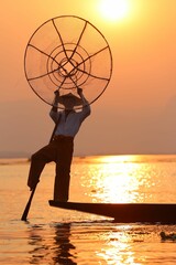 Wall Mural - Vertical shot of the Burma fisherman at sunset