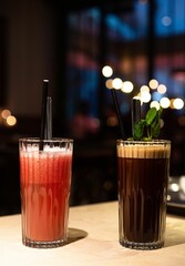 Selective focus of two glass cups of cocktails at the bar.