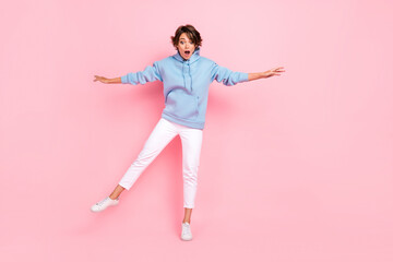 Poster - Full body photo of astonished terrified lady stylish clothes stand one foot look empty space high scary isolated on pink color background