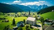 Aerial shot of St Magdalena church in Val di Funes valley, Dolomites, Italy