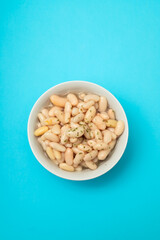 Sticker - fried cod fish with white beans on the plate