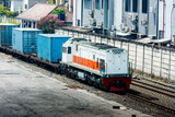 Fototapeta Miasto - Freight train locomotive carrying with cargo with blue sky background
