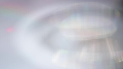 Wall Mural - Spectral Halo from the Edges of the Prism. Loop. Bright disk prismatic decomposition of a ray of light creating many rainbow faces on a light surface