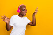Phhoto of cheerful funky lady enjoy dancing listen favorite playlist isolated on yellow color background