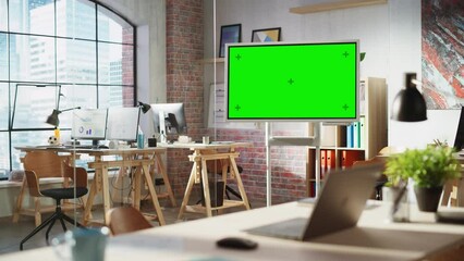Fototapete - Empty Conference Room for Team Meetings in Modern Creative Agency with Art on Walls and Desks with Computers. Office Space with Digital Green Screen Mock Up Chroma Key Monitor for Presentations.