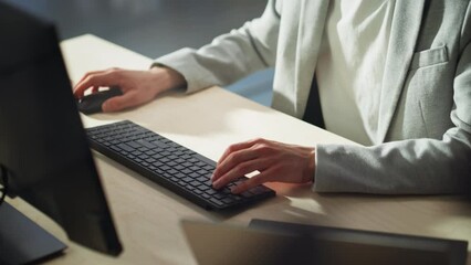 Poster - Young Male Employee in Gray Casual Jacket Working on Computer in Office During Daytime Close Up on Hands of a Manager Typing Texts on a Keyboard, Writing Text and Using Mouse.
