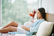 © GVS - Portrait of happy pregnant woman lying in bed and touching her belly at home