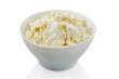 Home made cottage cheese in a white bowl on a white background isolated
