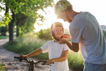 Shot of a father adjusting his son's helmet
