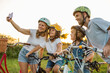 © pikselstock - Family taking a selfie while on a bike ride