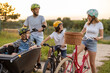 © pikselstock - Happy family cycling together in the countryside