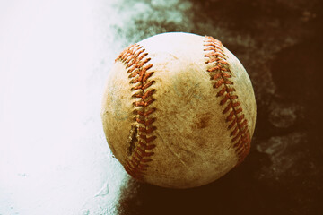 Wall Mural - Old vintage sports ball shows baseball closeup with copy space on background.