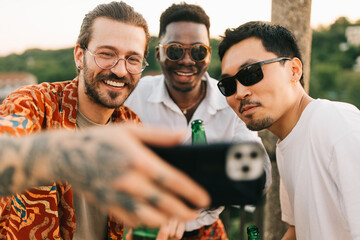 Wall Mural - The multicultural friends taking a selfie at the roof party.