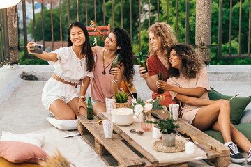 Bridesmaids take slefies at the bachelorette party.