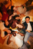 The top view of friends lying on the floor at a house party.