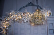© polly - Gorgeous interior decor. Christmas garland of white feathers, white branches and silver and white Christmas balls. A huge chandelier of mirror details against a white wall