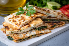 Traditional Turkish Food, Turkish Pancake Gozleme With Cheese And Herb. The Appetizer Is Turkish Pastry. There Are Varieties Such As Cheese, Spinach, Potato