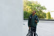 © makedonski2015 - Portrait of a happy African-American delivery man with a phone in his hands. The courier has arrived to the customer and is waiting for him outside.