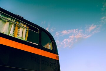 Sticker - Closeup of a vintage bus with blue sky in the background