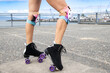 © Mat Hayward - Close up view of woman legs wearing roller skates with wheels and knee pads for safety and protection while having fun at the park.
