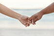 © Jesse B/peopleimages.com - Touch, love and support with interracial couple holding hands in a committed, loving and close relationship. Closeup hands of man and woman enjoying beach travel, sea vacation or holiday and romance