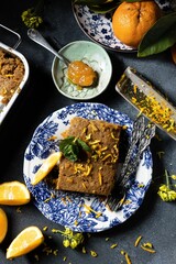 Sticker - Piece of banana bread with orange zest on beautifully decorated table - food aesthetic concept