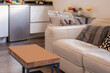 © Toyakisfoto.photos - Detail of a living room with a small coffee table and a white leather three-seater sofa