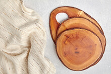 Wooden Cutting Boards Or Do-it-yourself Food Plate Coasters On A Light Concrete Table And Kitchen Towel With Copy Space
