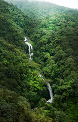 waterfall in the mountains surrounded by forest 