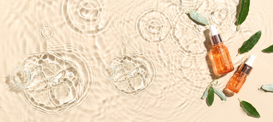 Wall Mural - Bottles of essential olive oil in water on beige background