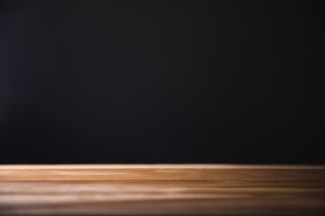 Poster - empty wooden table. dark background