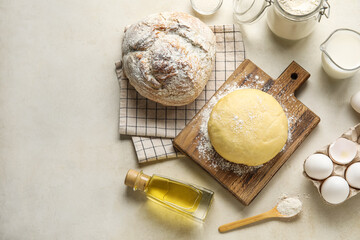 Composition with ingredients for baking and fresh bread on light background