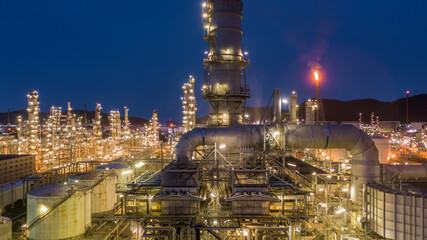 Wall Mural - Oil and gas refinery plant form industry zone at night, Aerial view oil and gas Industrial petrochemical fuel power and energy.