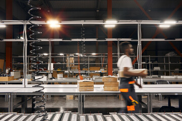 Wall Mural - african factory worker delivering box at the storage