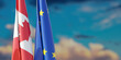 Canada and EU and relationship. European Union and Canadian  flags, cloudy sky.