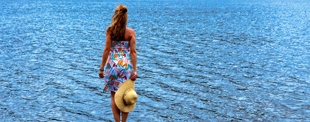 Wall Mural - happy freedom woman looking at blue sea horizon- free life,  positive, vacation concept