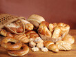 A variety of fresh pastries on a wooden table. Brown background. 