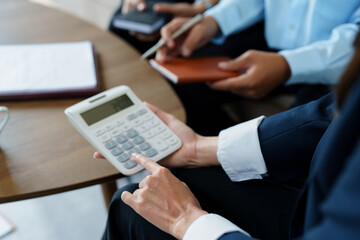 Wall Mural - bank employee uses a calculator to calculate loan rates for customers