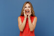 © ViDi Studio - Young fun caucasian woman 30s she wear red dress scream hot news about sales discount with hands near mouth isolated on plain dark royal navy blue background studio portrait. People lifestyle concept.