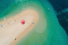 Aerial View Of Star Shaped Parasol On Beach On Zlatni Rat In Bol On The Island Of Brac, Croatia.