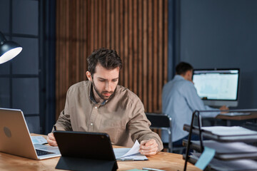 Canvas Print - employees working in the office until late at night.