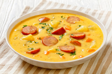 Wall Mural - German potato soup with sausages in bowl