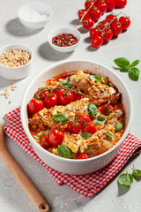 Wall Mural - chicken legs backed with feta cheese tomatoes and pine nuts, healthy meal