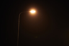 One Night Lamppost Shines With Faint Mysterious Yellow Light Through Evening Fog, Copy Space