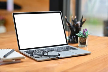 work space and co working space with empty screen of laptop placed on the desk.